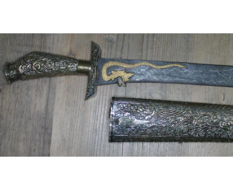 An Indonesian Java pedang, blade with gilt dragon and scorpion length 55.5cm, embossed grip and scabbard, total length 72cm. 