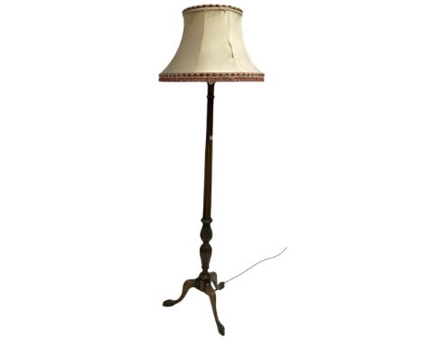 20th century stained beech standard lamp of classical design, with fluted turned column carved with water leaves, raised on t