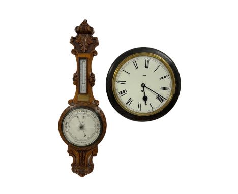 An Edwardian English solid oak carved hall barometer in a scroll shaped carved case with applied leaf carving, compensated An