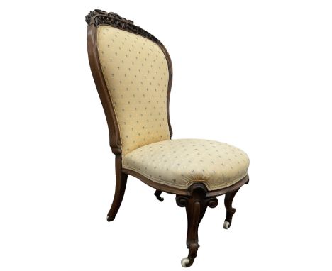 Victorian rosewood framed bedroom chair, pierced and scrolled floral carved cresting rail over seat and back upholstered in y
