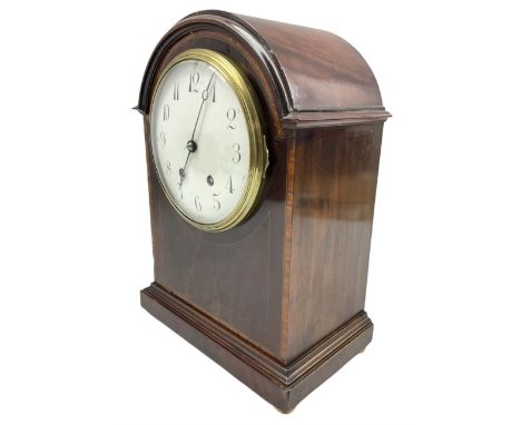 An Edwardian mahogany mantle clock with a break arch top, inlaid satinwood stringing and banding, case on a moulded plinth ra