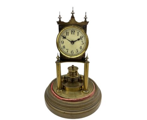 An early 20th century German torsion pendulum clock manufactured by Gustav Becker, with a 2-3/4� cream enamel dial within a s