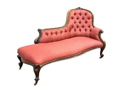 Victorian rosewood chaise longue, the shaped crest rail with floral carved pediment and scrolled terminals, button back and s