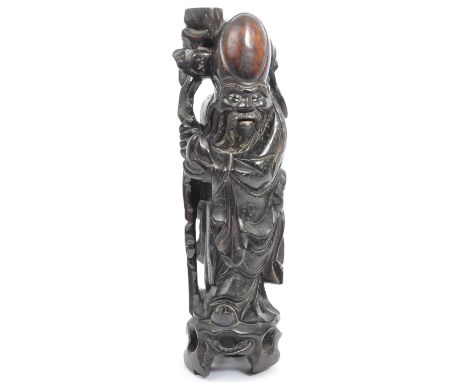 A 19th century Chinese figure, hand carved in the form of immortal&nbsp;Shouxing. The figure having inlaid silver to body. Co