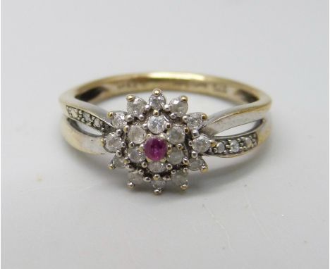 A 9ct gold, ruby and diamond cluster ring with diamond shoulders, 2.4g, M/N 