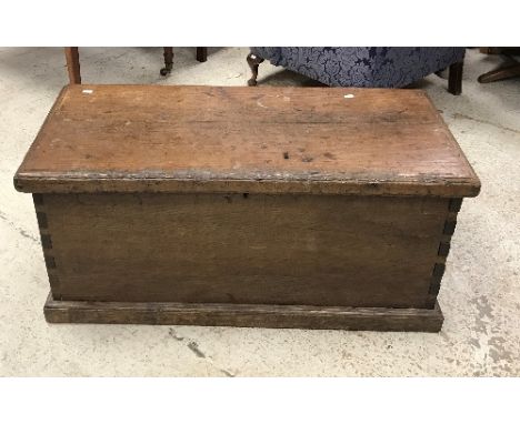 A 19th Century oak trunk, the plank top with applied moulded edge over plain sides, raised on a shallow plinth base, 98 cm wi