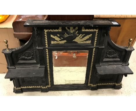 A Victorian cast iron overmantel mirror with central eagle and sunburst relief work panel over a rectangular bevel edged mirr