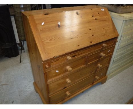 A modern pitch pine bureau, the sloping fall above one long, two short and two further long drawers on bracket feet, 93 cm wi