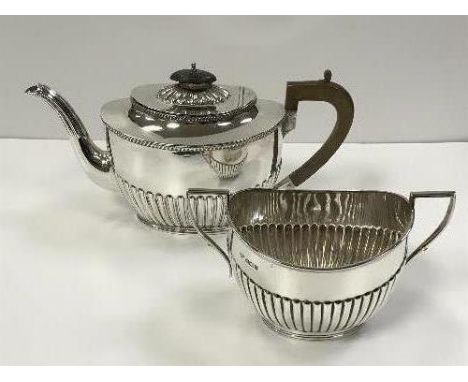 A late Victorian silver teapot of half reeded decoration (by Harrison Brothers and Howson, Sheffield 1891), together with an 