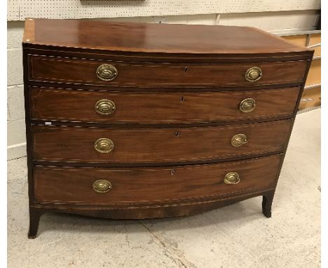 A late Regency mahogany bow fronted chest, the cross-banded and satinwood strung top over four long graduated drawers with pr