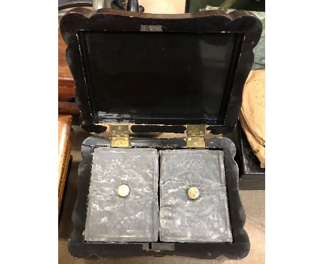 A 19th Century black lacquered and chinoiserie decorated tea caddy of shaped rectangular form, the side panels with studies o