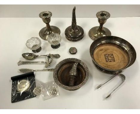 A silver sauce ladle, teaspoon, butter knife and sugar tongs together with a pair of loaded silver candlesticks, a pair of ho
