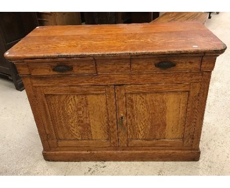 A 19th Century French painted pine buffet decorated in faux light oak, the plain top over two drawers and two cupboard doors 