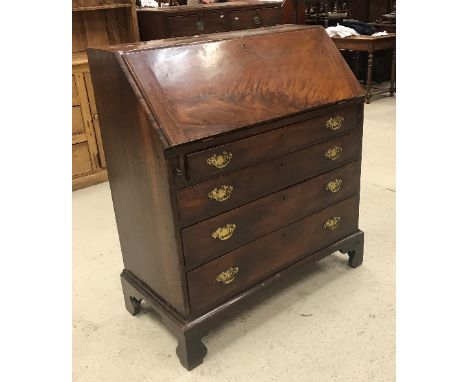 A 19th Century mahogany bureau, the plain top above a sloping fall enclosing a basic fitted interior and shelves over four lo