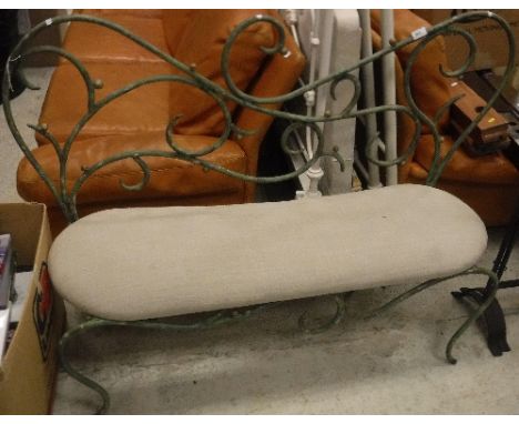 A modern verdigris patinated scrollwork iron framed bench with upholstered seat, 139 cm wide x 40 cm deep x 95.5 cm high COND