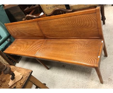 A vintage "Stella" bistro bench with tambour style panelled back and seat, raised on square supports, bears transfer mark to 