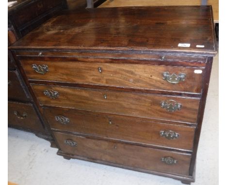 A George III mahogany bachelor's chest, the plain top with applied moulded edge over a brushing slide and four long graduated