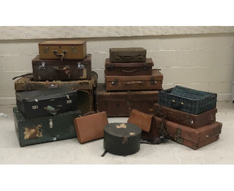 A canvas and leather bound trunk, a canvas strapwork trunk, eight various suitcases and a hat box