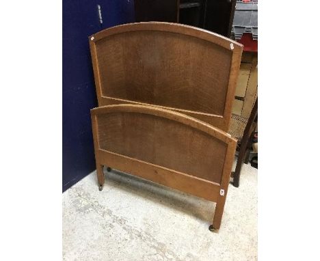 A Heal's oak single bedstead in the Cotswold School manner, bears ivorine tag "Heal's Tottenham Court Road London W1", 91.5 c