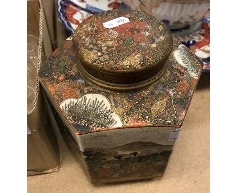 A 19th Century Japanese Meiji period Satsuma hexagonal tea caddy and cover, the main body decorated with figures in a landsca