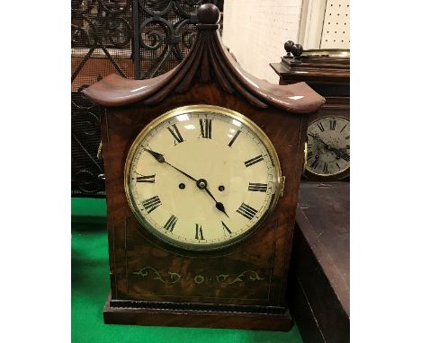 A circa 1830 mahogany and brass inlaid bracket clock, the pagoda top with moulded decoration above a figured brass inlaid fro