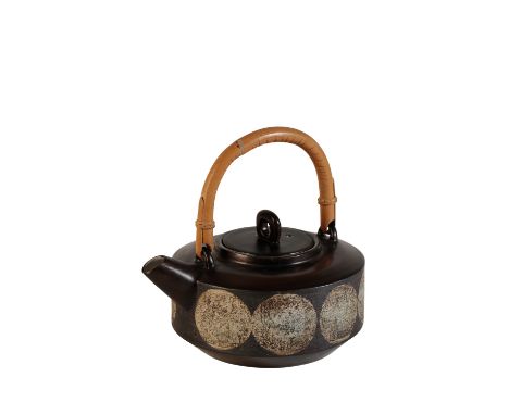TROIKA: A ST IVES CERAMIC TEAPOT, circular compressed form, pull-off cover with bamboo swing handle, the body decorated with 