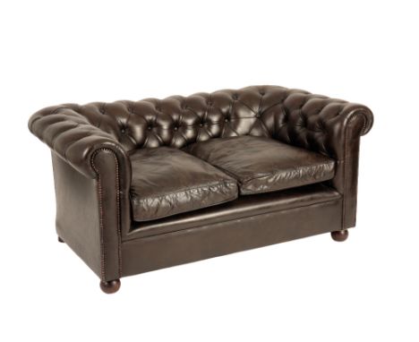 TWO-SEATER CHESTERFIELD LEATHER SOFA, upholstered in dark brown with button-back seat and pad, raised on turned wooden feet, 