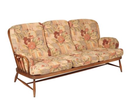 ERCOL: A "WINDSOR" THREE SEATER SOFA, with padded cushions, 193cm wide x 83cm high x 92cm deep, and two "203" arm chairs, 79c