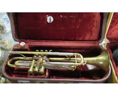 A boxed trumpet and another musical instrument