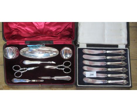 A cased silver manicure set, together with a cased set of tea knives