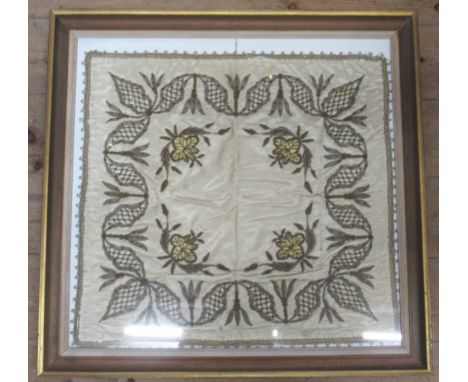 A framed embroidery of silver and gold coloured thread on silk