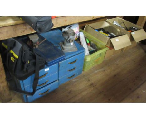 A tool chest and various boxes of tools and two step ladders