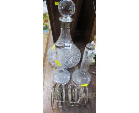 Two silver toast racks, a pair of glass vases, with silver collars, a decanter with silver collar and various spoons