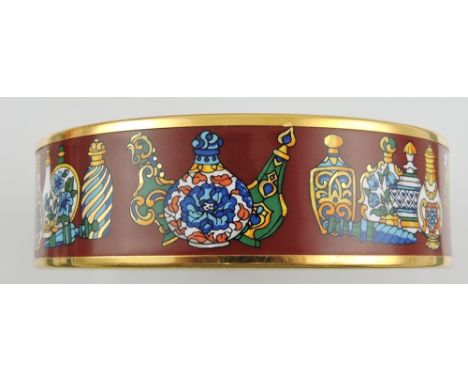 A Hermes gold tone enamel bangle bracelet, red exterior decorated with Iznik vessels in original card box, Dia. 7 cm