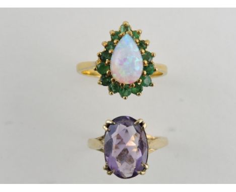 An amethyst dress ring, the oval claw set stone in a 9ct gold band, together with an opal and emerald cluster ring, total wei