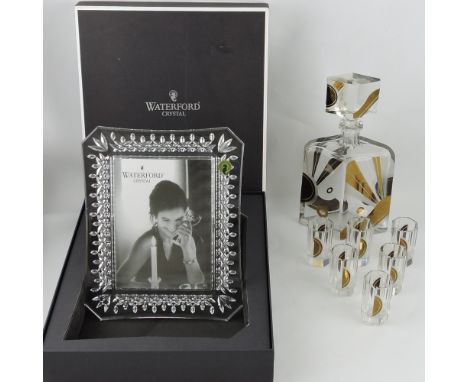 An Art Deco style decanter and glasses, the navette shaped decanter with stylised sun-burst, together with six octagonal shap