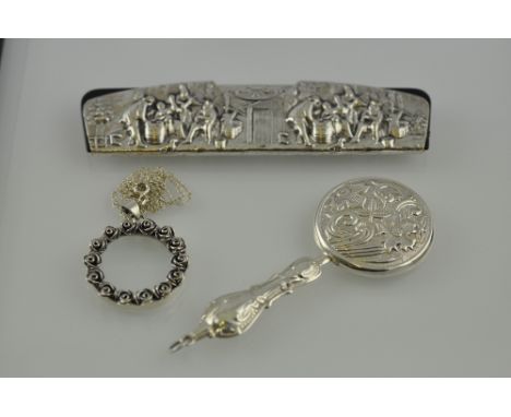 A comb with Continental white metal mount, depicting figures at their labours; together with an eyeglass and a hand mirror. (