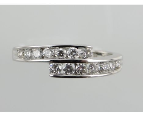 An 18ct white gold diamond ring the 14 chanell set stones in bypass setting, approx. 0.5ct