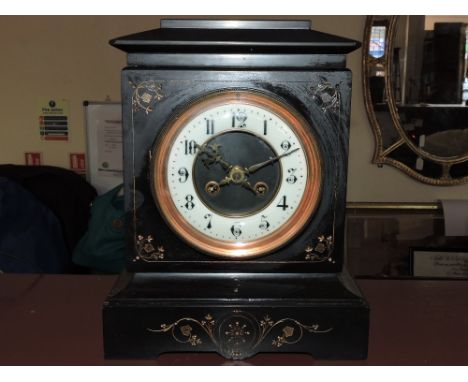 A late Victorian black slate mantel clock, the case with a gilt foliate design and white chapter ring set out in Arabic numer