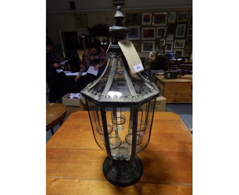 A vintage style octagonal glazed lantern with tea light interior.