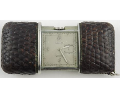 An early 20th Century Movado Ermeto chronometer travelling watch with easil back and textured leather outer cover the square 