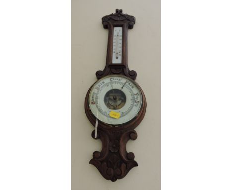 A late Victorian oak aneroid wheel barometer and thermometer.