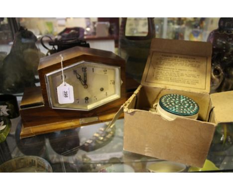 An Art Deco walnut mantel clock together with a vintage gas mask.