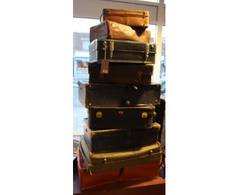 A collection of 11 vintage suitcases. 