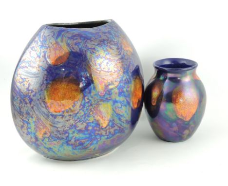 A Poole Pottery Metallic Galaxy Purse vase, with purple iridescent glaze, H. 27cm; together with a similar smaller vase. (2)