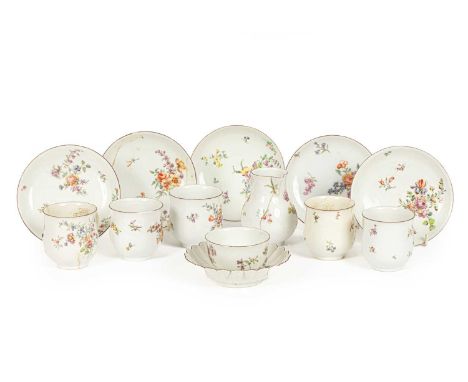 A Chelsea part service painted with flower sprays, circa 1755, comprising five bell-shaped cups and saucers, a tea bowl, a mi