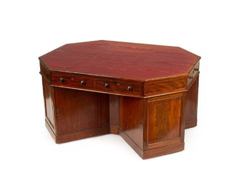 A Victorian Irish mahogany octagonal partner's desk, the frieze with four short and one long drawer, the offset pedestals eac