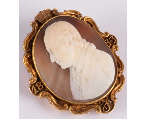 A William IV shell cameo brooch, the oval cameo with bust-length profile portrait of a gentleman, the gold frame surmounted b