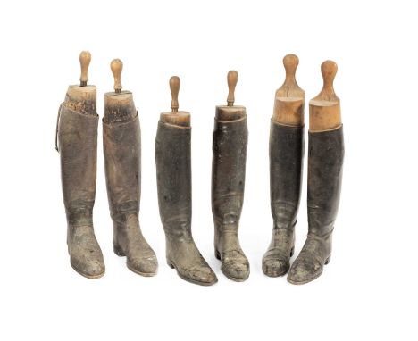Three pairs of leather hunting boots with wooden trees, three pairs of spurs, and a pair of boot pulls  Left hand pair – in v