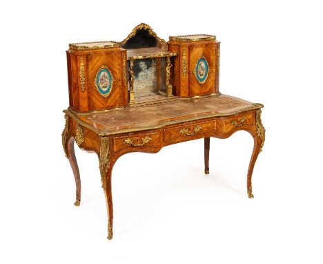 A Victorian ormolu mounted tulipwood and kingwood desk in the Louis XV style, the superstructure with mirror back and a shelf